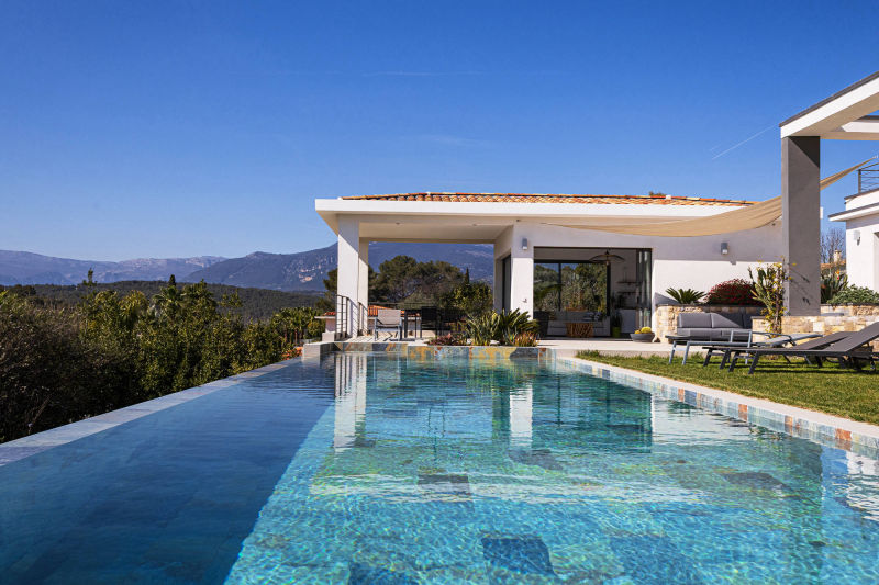 Custom pool and outdoor living area seamlessly integrated into the natural Mediterranean landscape.