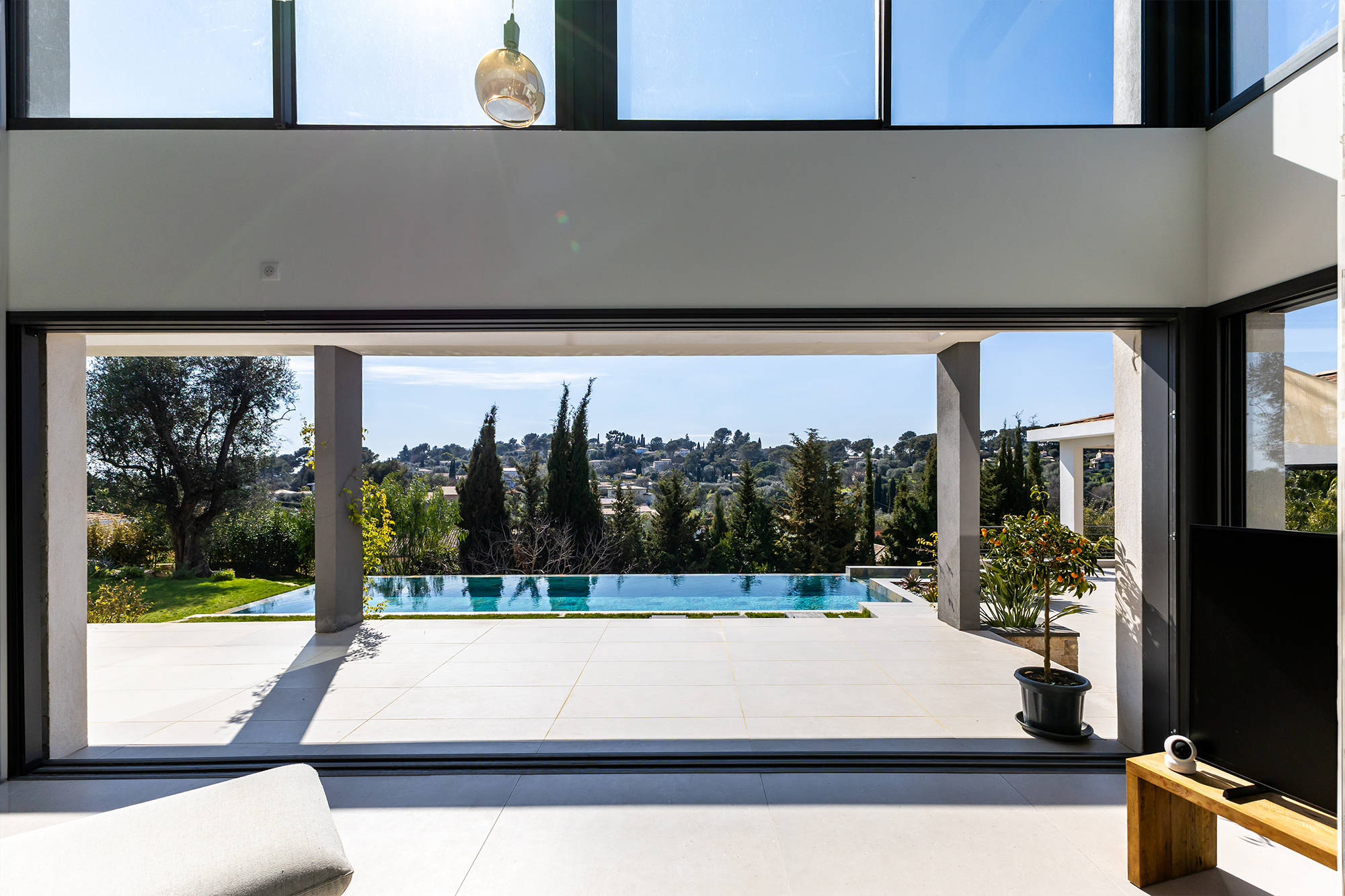 Custom-designed villa with large bay windows and pool.