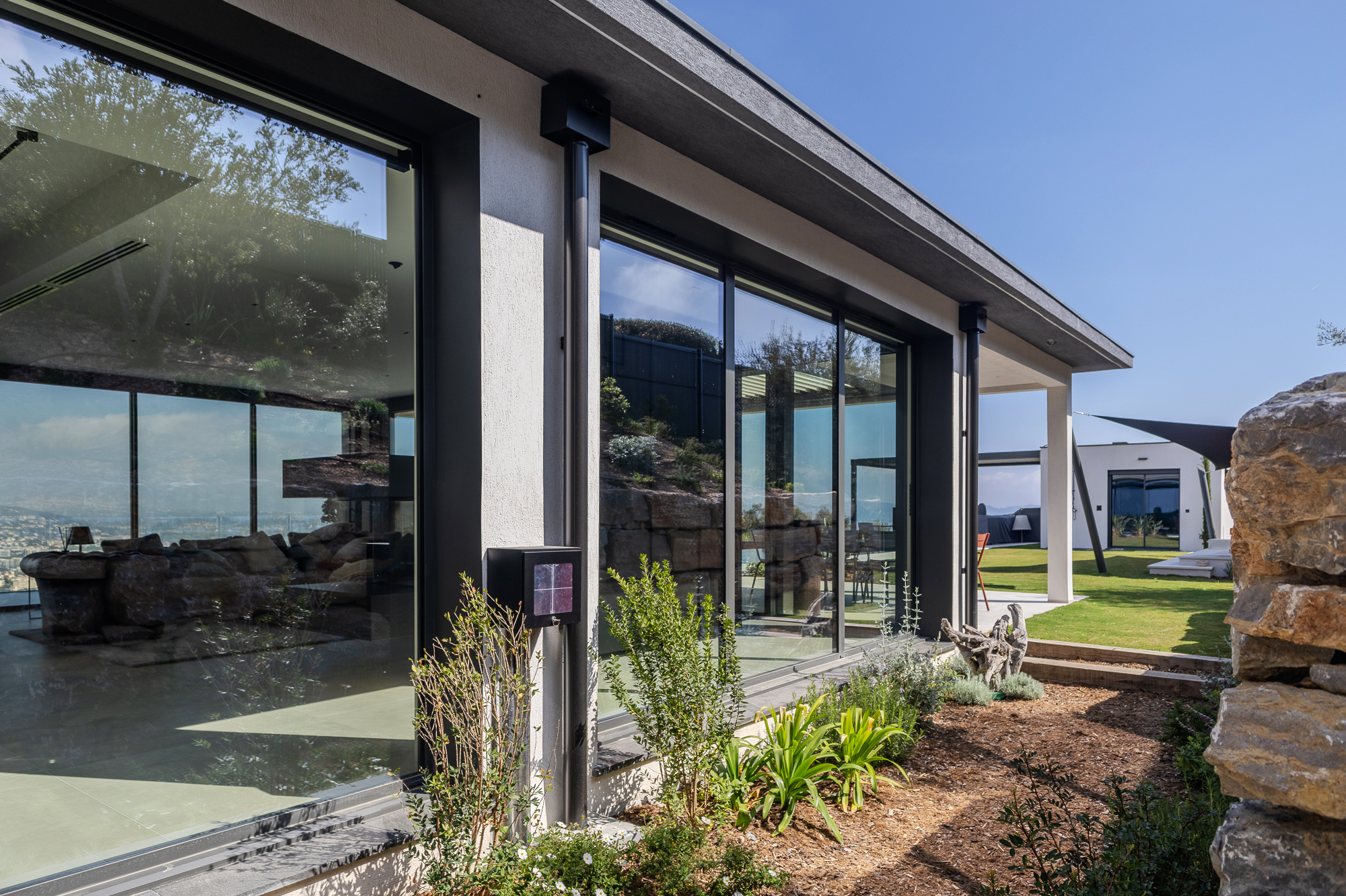 High-end outdoor living space with covered terrace and pool house