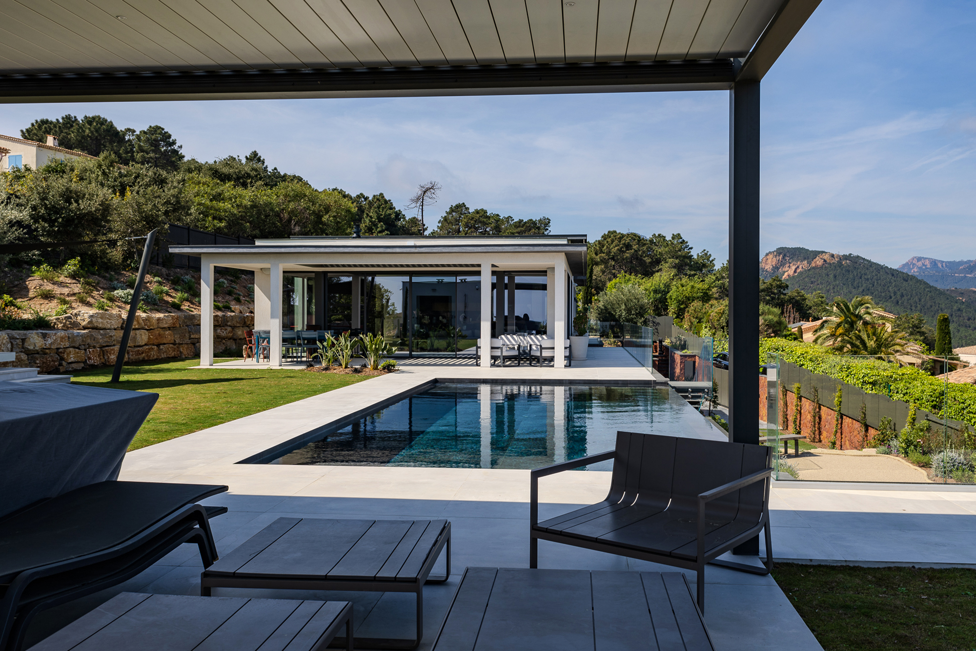 Modern luxury home with outdoor terrace and pool area.
