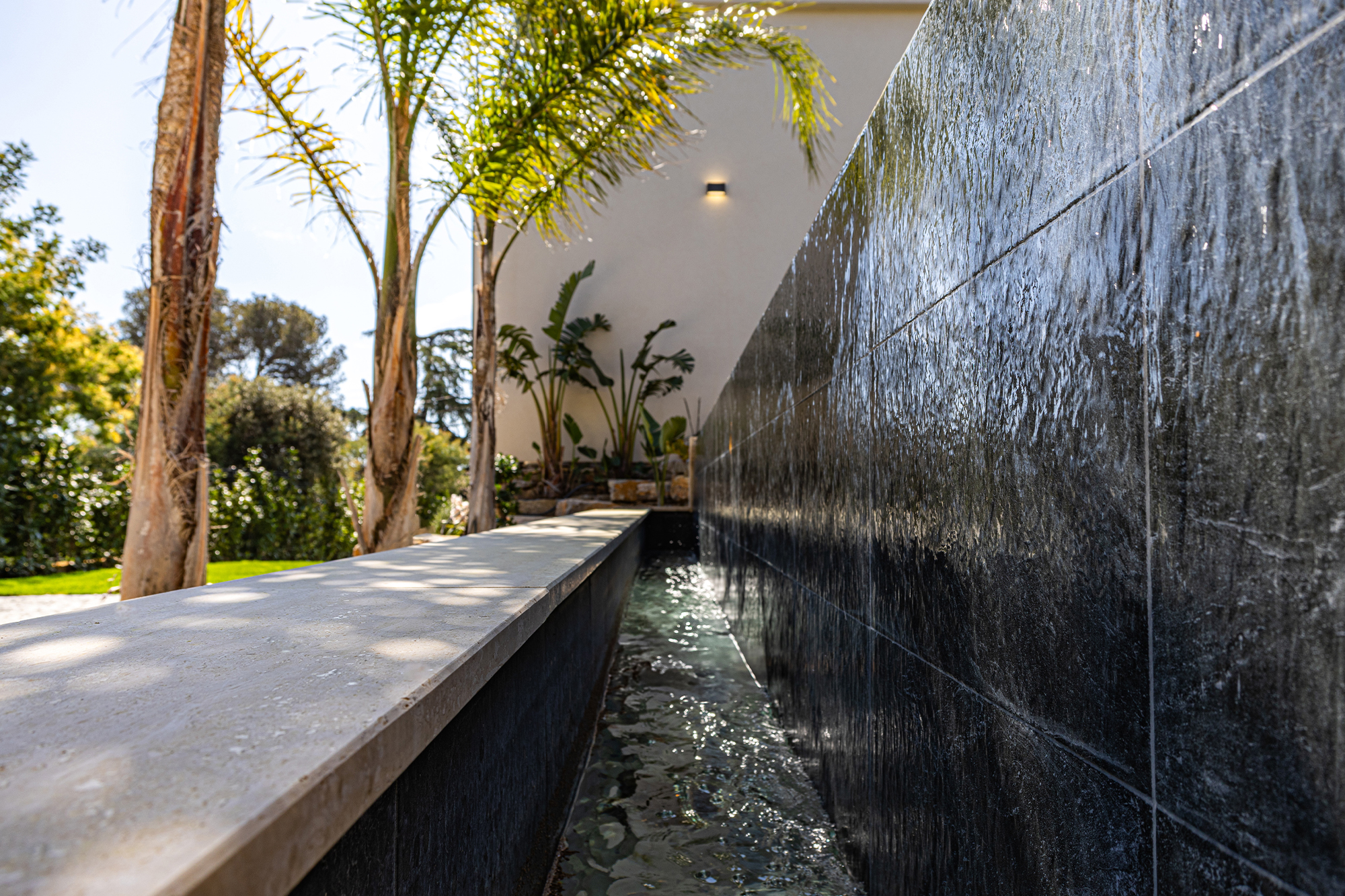 High-end renovation with infinity pool and natural stone features.