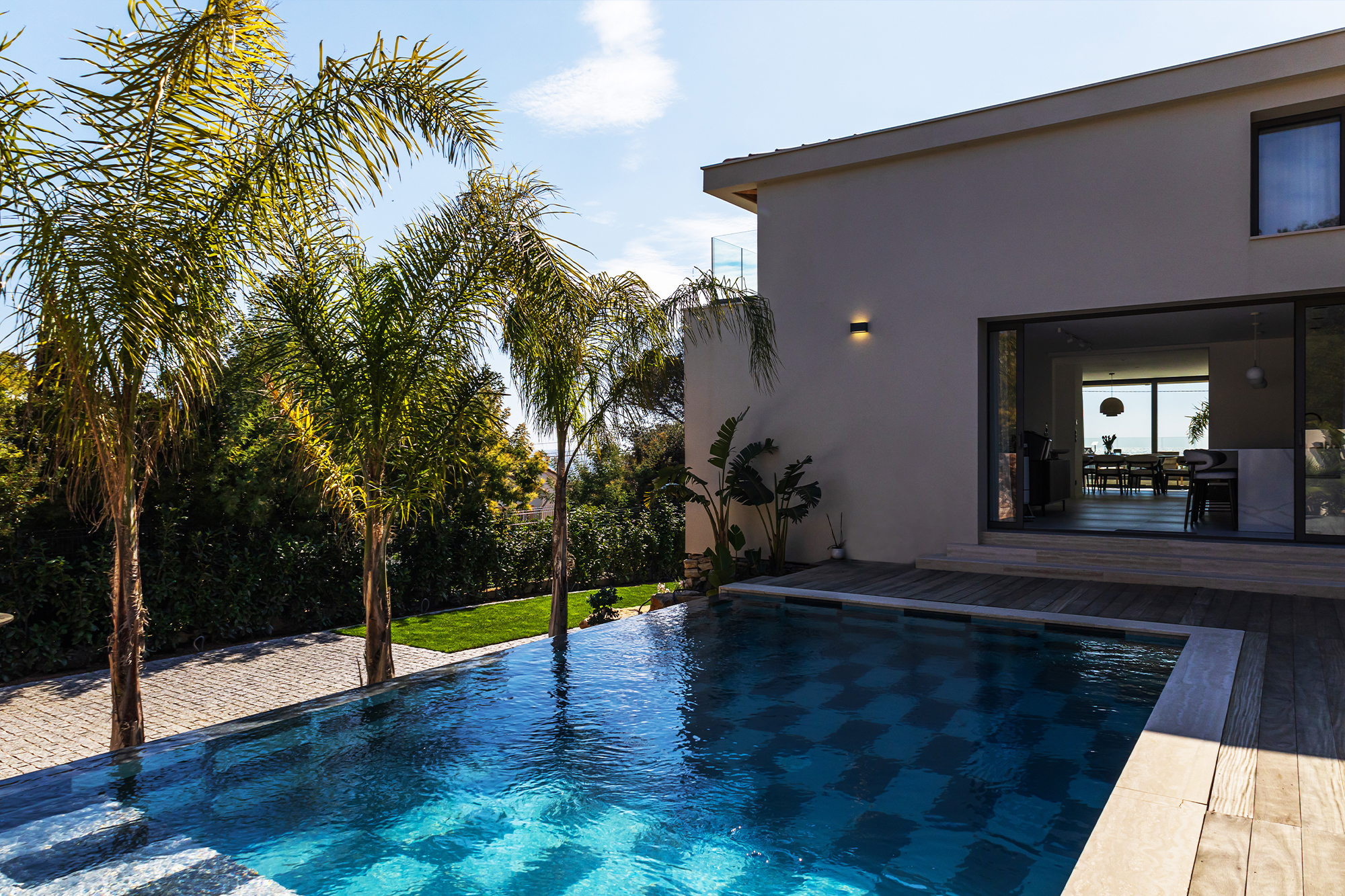 High-end pool renovation with mosaic tiles and outdoor space.