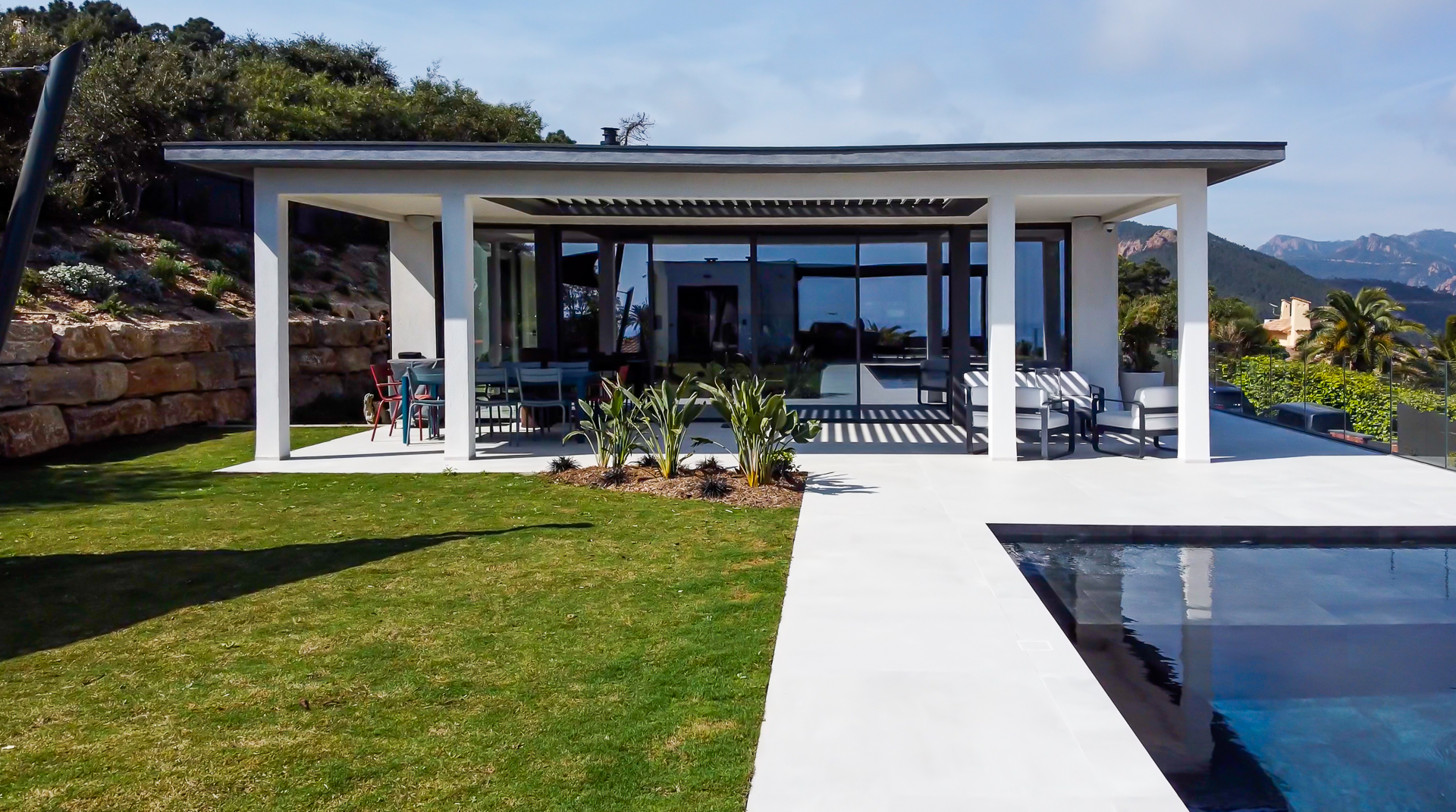 Contemporary villa architecture with flat roof and pool panoramic views.